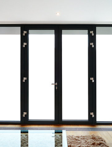 A spacious room featuring black Eclisse Sliding Door Systems in Southern California