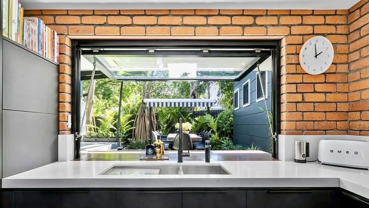 Kitchen window opening to outdoor patio